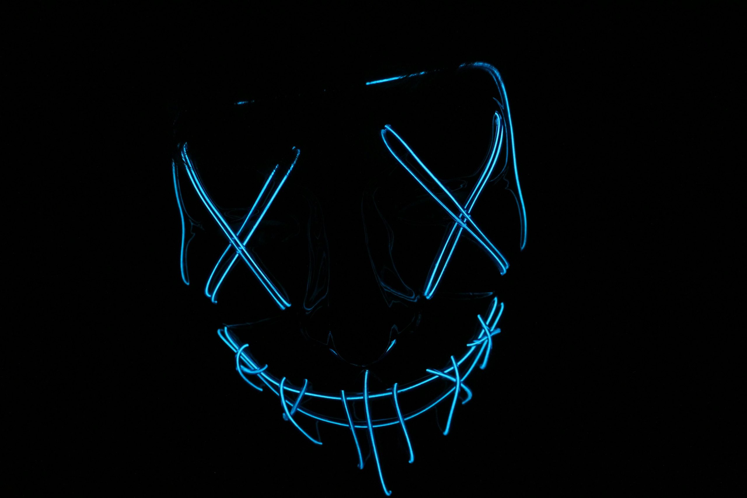 Futuristic neon blue LED mask glowing in the dark, ideal for tech and cyber themes.